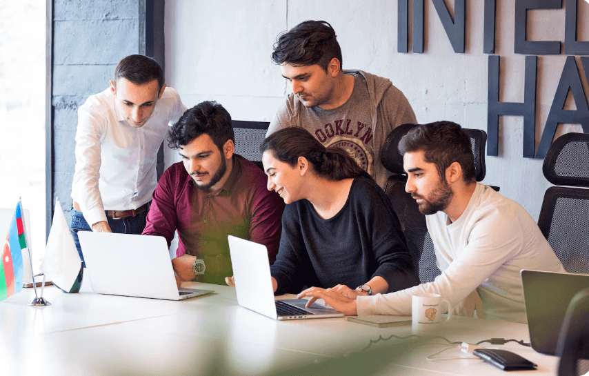 Professionals discussing project details in a modern coworking space
