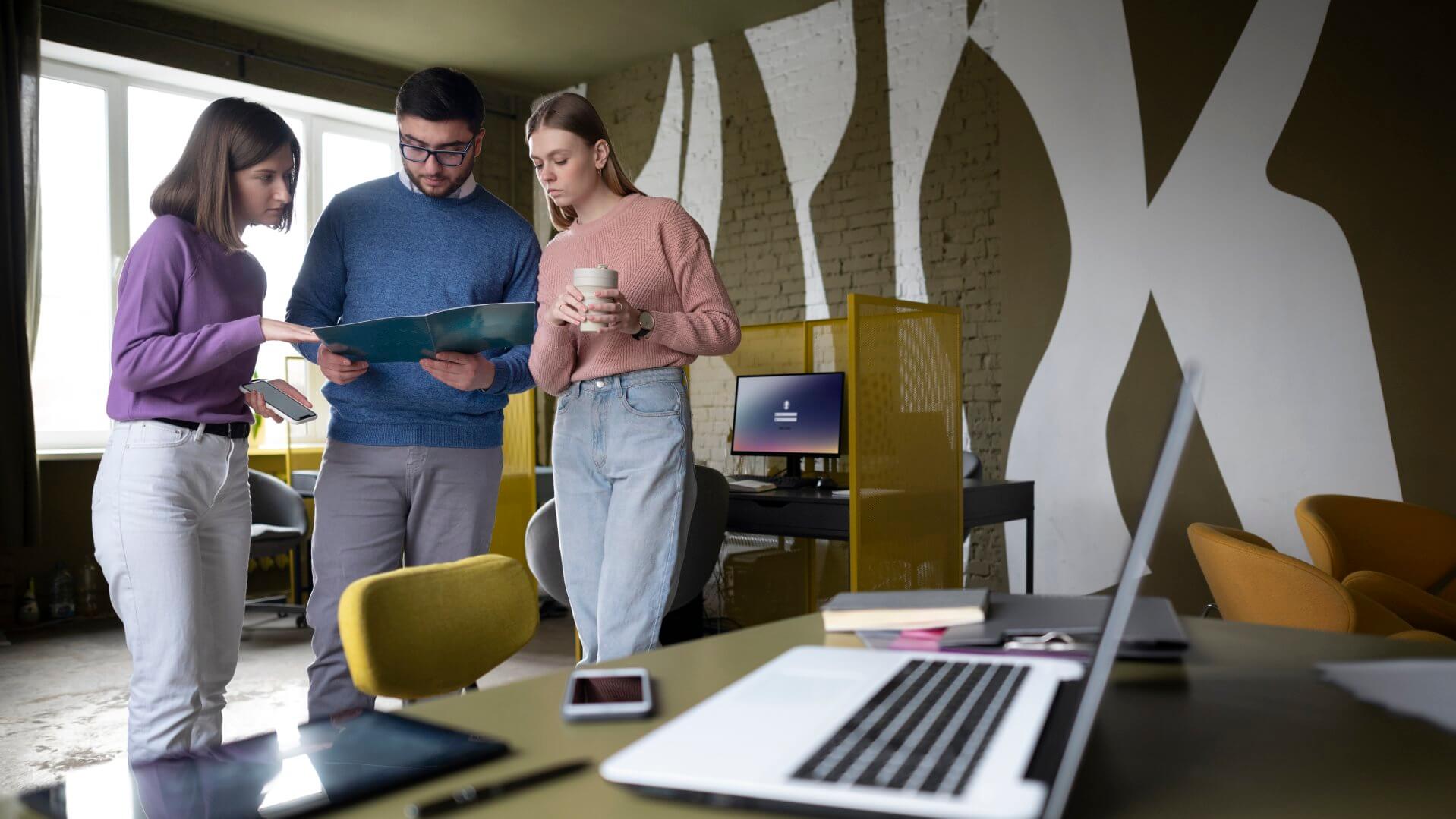 Professionals collaborating on a project in a modern coworking space Professionals collaborating on a project in a modern coworking space