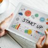 Entrepreneur planning startup growth on digital tablet