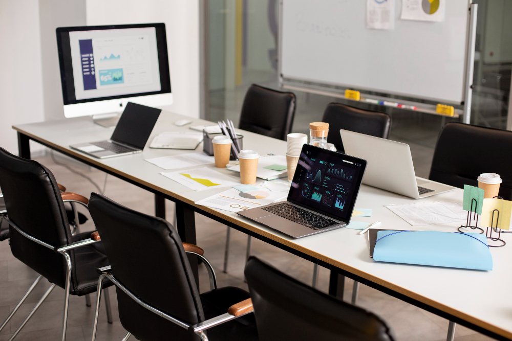 Small team working on laptops in a modern coworking space with collaborative amenities