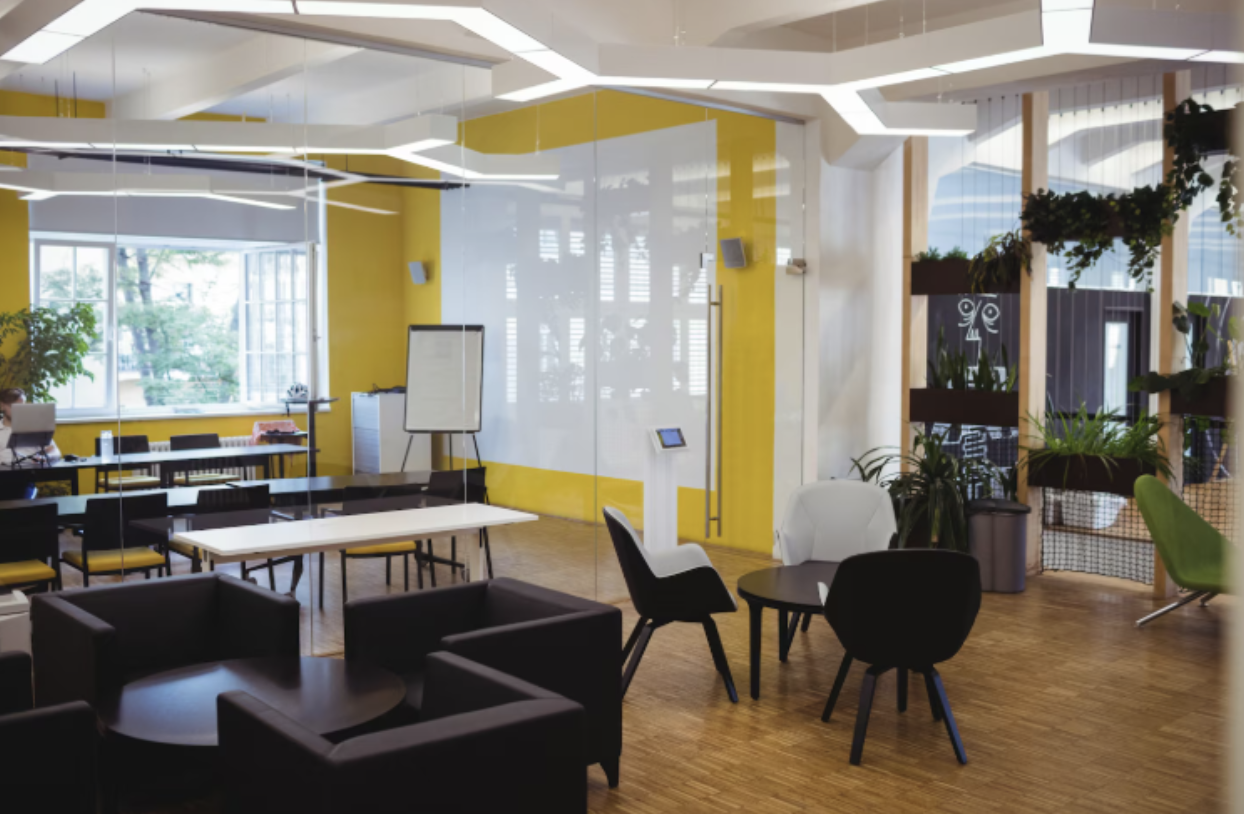 Modern coworking office with meeting tables and lounge seating Modern coworking office with meeting tables and lounge seating